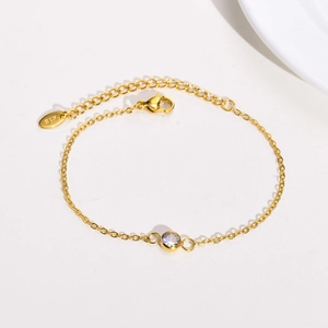 Gold stainless steel thin chain bracelet with a single round cubic zirconia stone