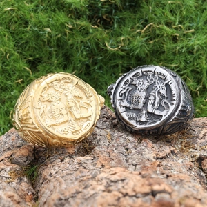 Detailed relief of vintage Egyptian skull rings in gold and silver on natural tree bark