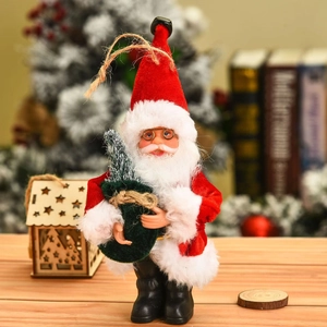Detail of Santa Claus figure with white beard, glasses, and green gift bag on a desk