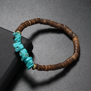 Detail of bohemian bracelet with turquoise stones, coconut wood beads and gold accents