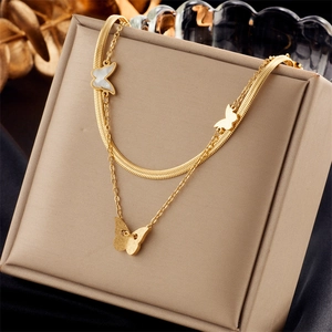 Detail of gold double-layer butterfly necklace with mother of pearl pendant on display