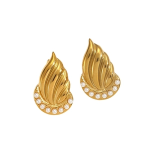 Flame shaped 18k gold plated titanium steel earrings with white pearls on white background