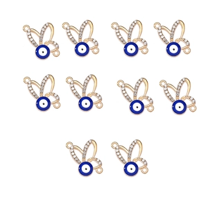 Detailed view of 10 golden butterfly evil eye connectors with rhinestones for DIY jewelry