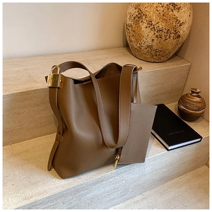 Detail of lychee pattern leather tote bag with gold lock charm and matching coin pouch