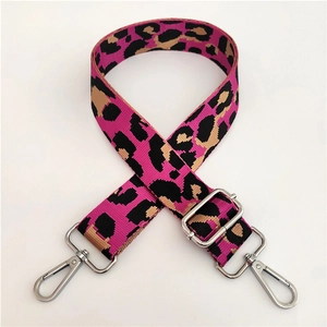 Macro detail of leopard print adjustable wide canvas shoulder strap with silver hooks