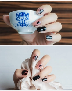 Detail of oriental ink wash style press-on nails with lotus and bird hand-painted motifs