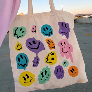 Retro canvas tote bag in ivory with colorful melting smiley face glitter print