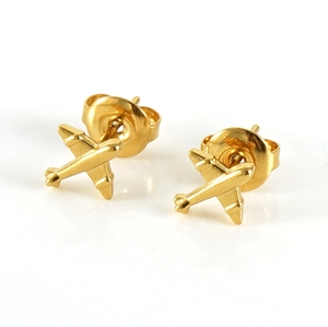 Detail view of gold airplane stud earrings with a polished finish on a white background