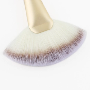 Fan-shaped highlighter brush with golden handle and soft synthetic white bristles