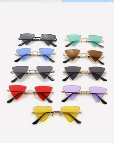 Flat lay of geometric triangle sunglasses in various colors with metallic frames