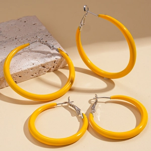 Minimalist yellow enamel hoop earring set on natural stone, featuring two sizes