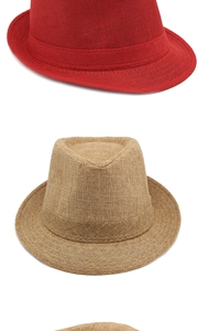 Detail of red and khaki woven sun hats showing texture and matching decorative bands