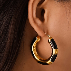 Fashionable gold-plated stainless steel hoop earrings with black leopard print enamel detail