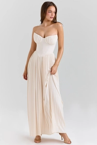Detail of the pleated bodice and corsetry structure on the cream strapless maxi dress