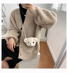 White cartoon bear plush crossbody bag shown on a beige knit sweater for a daily outfit