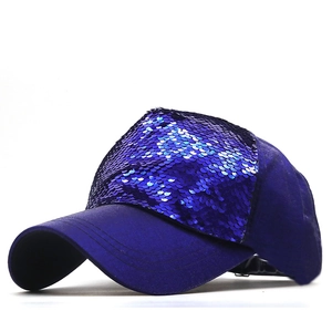 Detail of dark blue baseball cap showing reflective sequins and curved brim texture