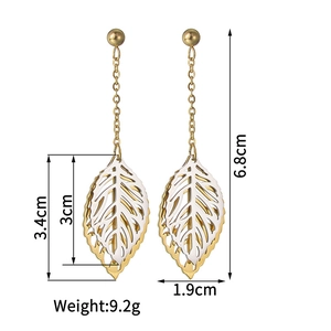 Detailed view of vintage gold and silver leaf earrings with exact dimensions and weight