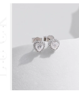 Detail of S925 sterling silver heart stud earrings with sparkling moissanite stones
