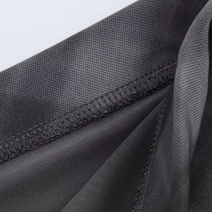 Macro shot of dark gray mesh fabric detailing breathable grid texture and stitching