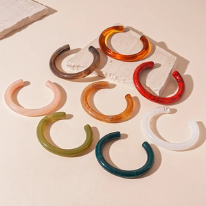 Set of 8 vintage acrylic C-shaped open bangles with marble and tortoiseshell patterns