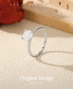 Macro detail of square cut moissanite ring with S925 silver pave band on elegant background