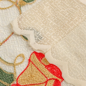 Lace Christmas curtain with embroidered bells and holly on cream mesh fabric