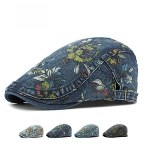 Detailed close-up of retro floral denim beret cap featuring vintage prints and adjustable buckle