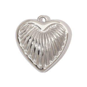 Close-up of heart-shaped stainless steel pendant with radial striped texture and top loop
