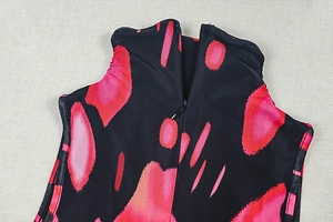 Close-up of red and black abstract print fabric with a back invisible zipper detail