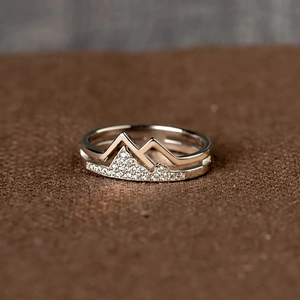 Macro shot of double-layered mountain ring with sparkling zircon inlays for couples