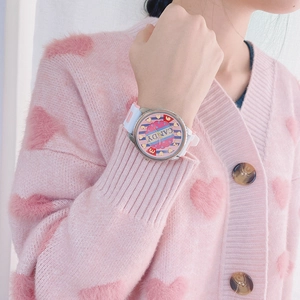 Close-up of a white silicone strap watch with a pink candy-themed cartoon dial