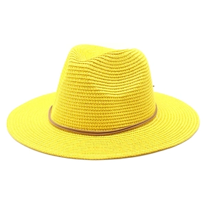 Detail of yellow straw fedora with fine weaving and brown synthetic leather band