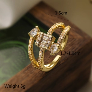 Macro view of gold-plated double-row geometric ring with marquise and square zircons