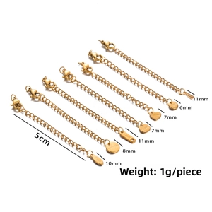 Detail view of 5cm gold stainless steel extender chains with diverse charm designs