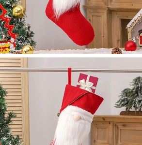 Detail view of a red velvet Christmas gnome stocking with white plush trim for gifts
