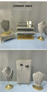 Detail of light gray velvet jewelry display stand with golden metal support frame