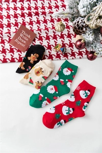 Close-up of festive cotton Christmas socks featuring Santa, snowman, and reindeer motifs