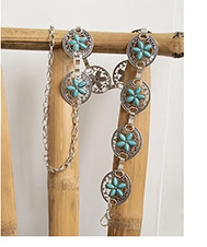 Detailed close-up of a silver boho waist chain with turquoise blue floral medallions