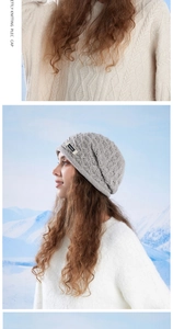 Detail of grey diamond-knit wool hat featuring a side label against a snowy mountain backdrop