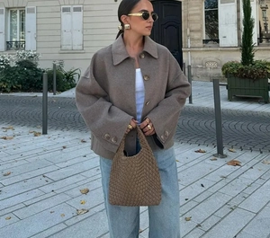 Brown wool short jacket featuring large lapels and oversized buttons in an outdoor street setting