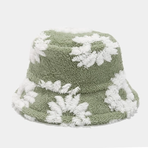 Close-up of grass green plush bucket hat with soft white floral fleece patterns