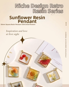 Macro shot of a 30mm square resin pendant with real dried flowers and golden alloy frame