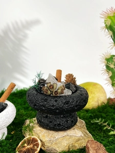 Detailed close-up of a black essential oil diffuser with crystals and natural botanicals