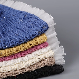 Close-up of colorful knit bucket hats with mesh lace trim and shimmering sequins details