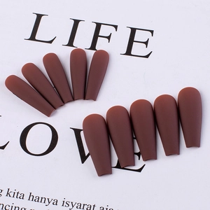 Detail of matte dark red-brown press-on nails showing smooth frosted finish texture