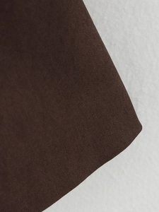 Close-up of premium brown twill fabric texture for women's casual suit jacket