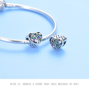 Macro shot of S925 sterling silver family tree heart charms with colorful zircon stones