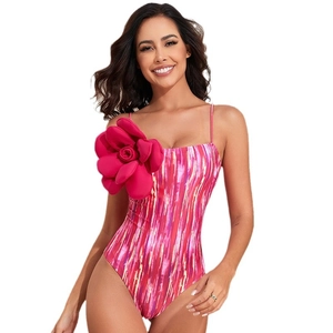 Pink and purple artistic textured one-piece swimsuit featuring a 3D fabric flower on shoulder