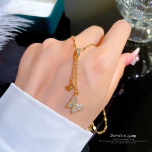 Elegant gold-tone double-layered butterfly pendant necklace with micro-paved cubic zirconia