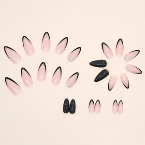 French black tip almond press-on nails with glitter accents and elegant nude base
